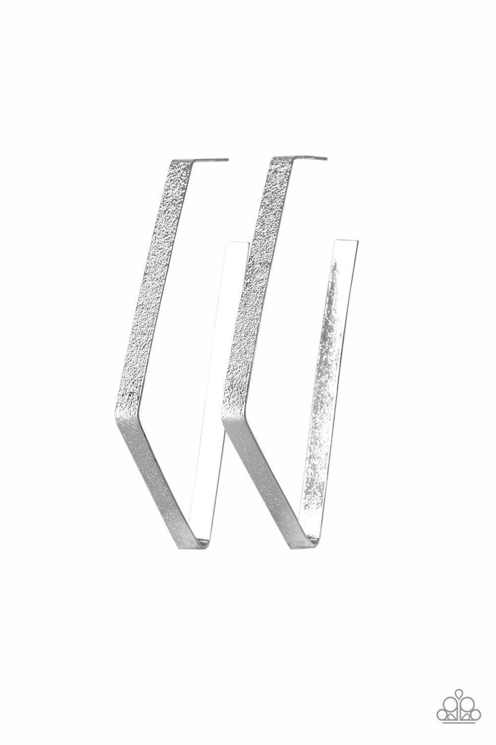 Paparazzi Accessories Way Over The Edge ~Silver Hammered in a glittery finish, a flat silver ribbon bends into an asymmetrical hoop for an edgy look. Earring attaches to a standard post fitting. Hoop measures approximately 1 1/2" in diameter.