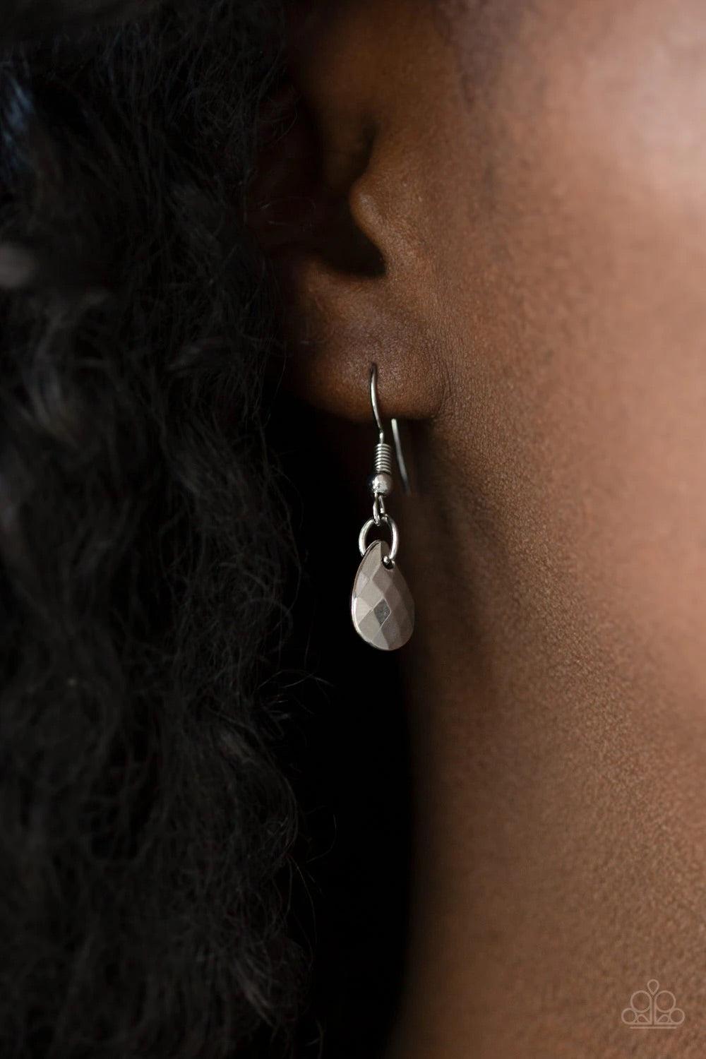 Paparazzi Accessories Bravo Bravado - Silver Mismatched silver chains layer down the chest. Faceted silver teardrops and shiny silver accents swing from two of the shimmery silver chains for an edgy finish. Features an adjustable clasp closure. Sold as on