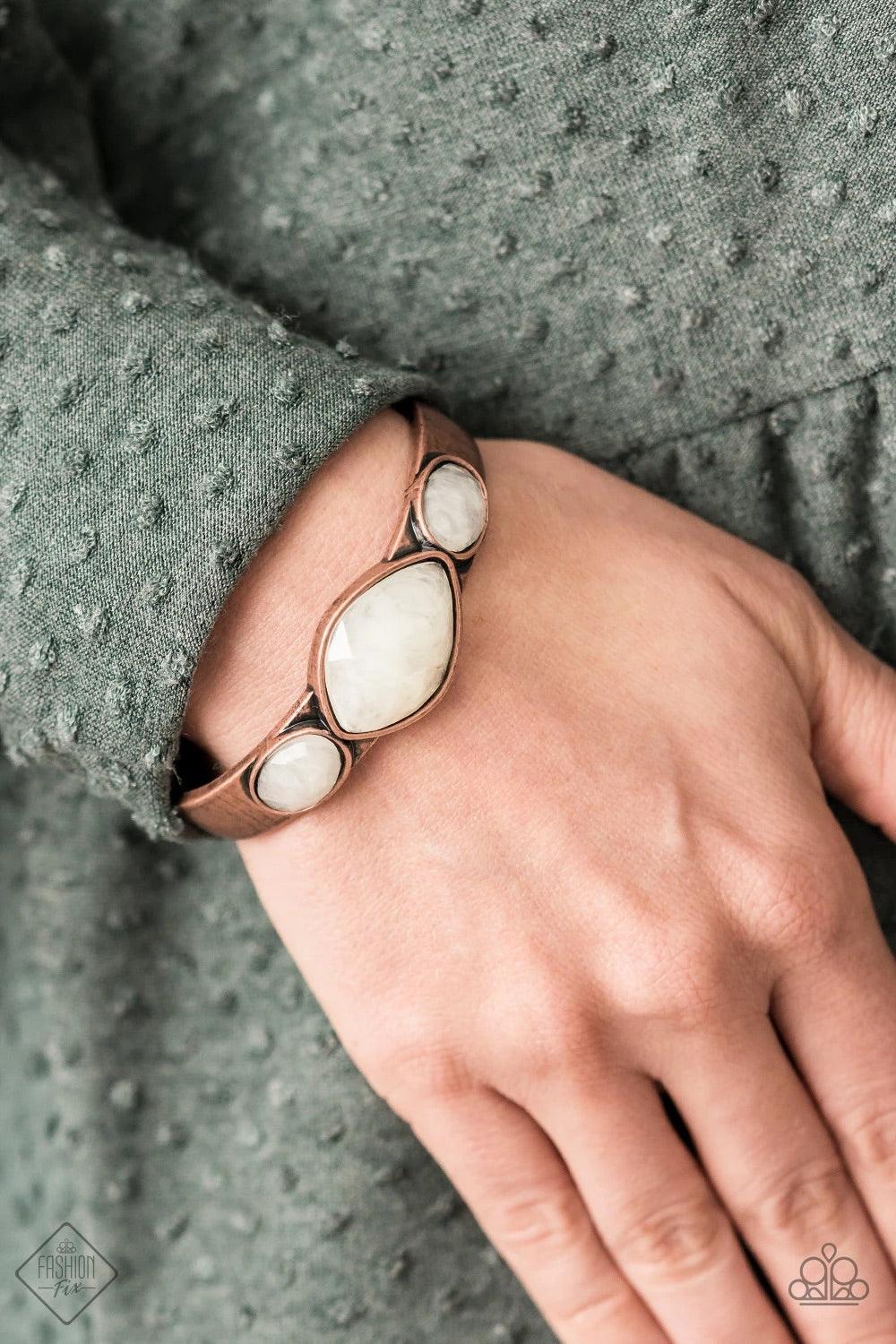 Paparazzi Accessories Next Stop, Olympus! - Copper Featuring faceted surfaces, an asymmetrical collection of cloudy faux stone beads are pressed along the spine of a rustic copper cuff, creating a mystical accent piece that wraps around the wrist. Sold as