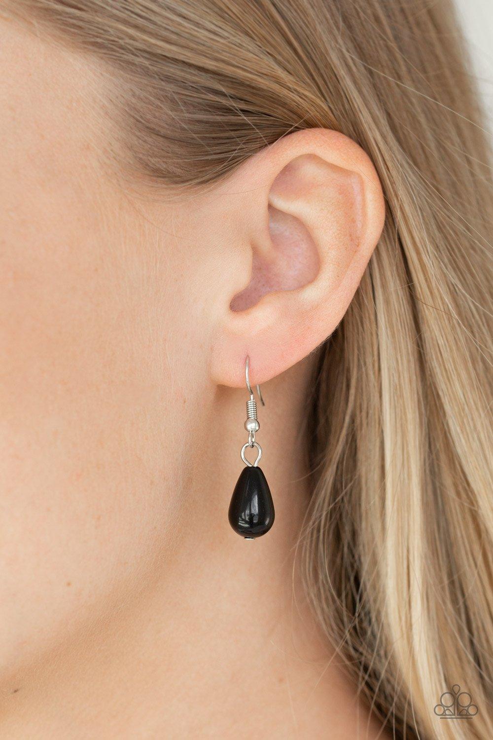 Paparazzi Accessories The Guest List - Black Threaded along metallic rods, pairs of black beads are stacked between two silver chains. Matching black beads and shiny black teardrops drip from the bottom, creating a refined fringe below the collar. Feature