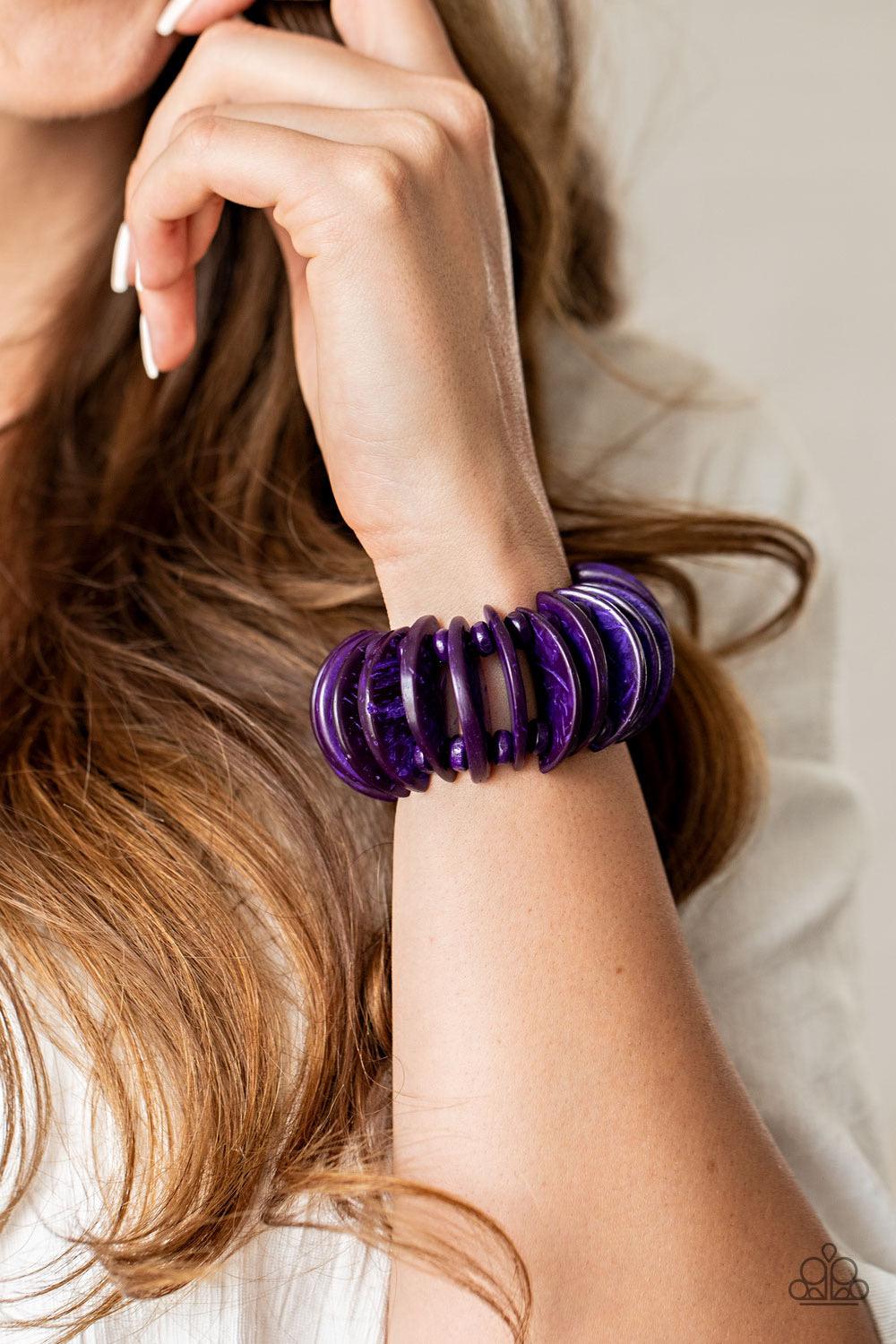 Paparazzi Accessories Tropical Tiki Bar ~Purple Infused with purple wooden beads, distressed purple wooden crescents are threaded along stretchy bands around the wrist for a summery look. Sold as one individual bracelet.