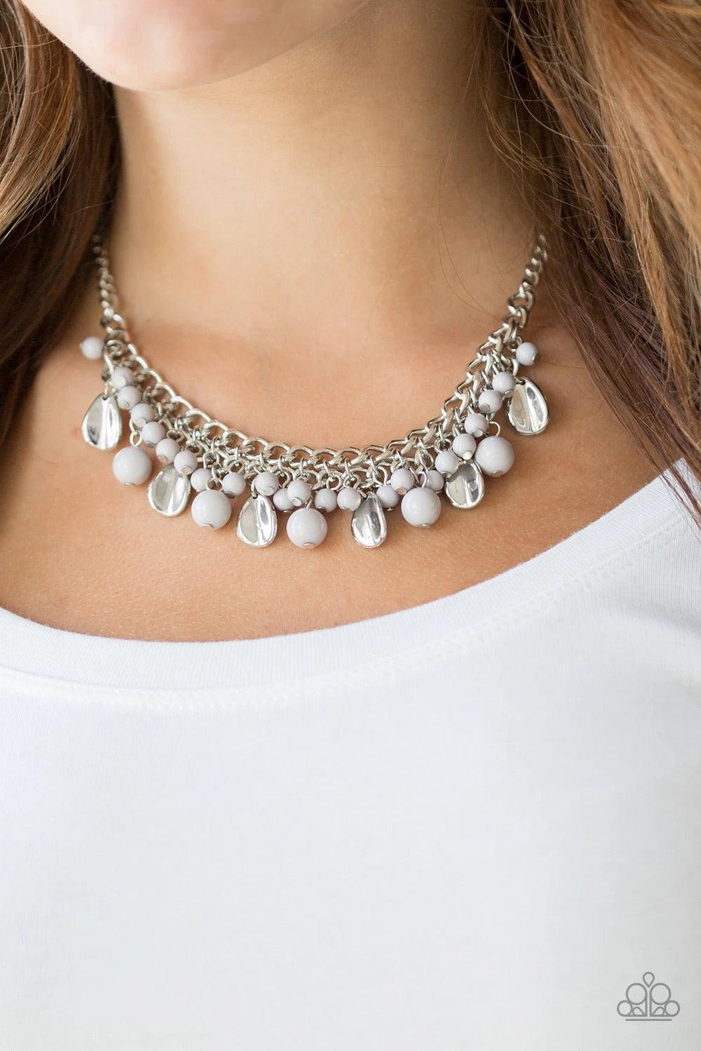 Paparazzi Accessories Summer Showdown - Silver Neutral gray beads and curved silver teardrops swing from the bottom of interlocking silver chains, creating a flirtatious fringe below the collar. Features an adjustable clasp closure. Sold as one individual