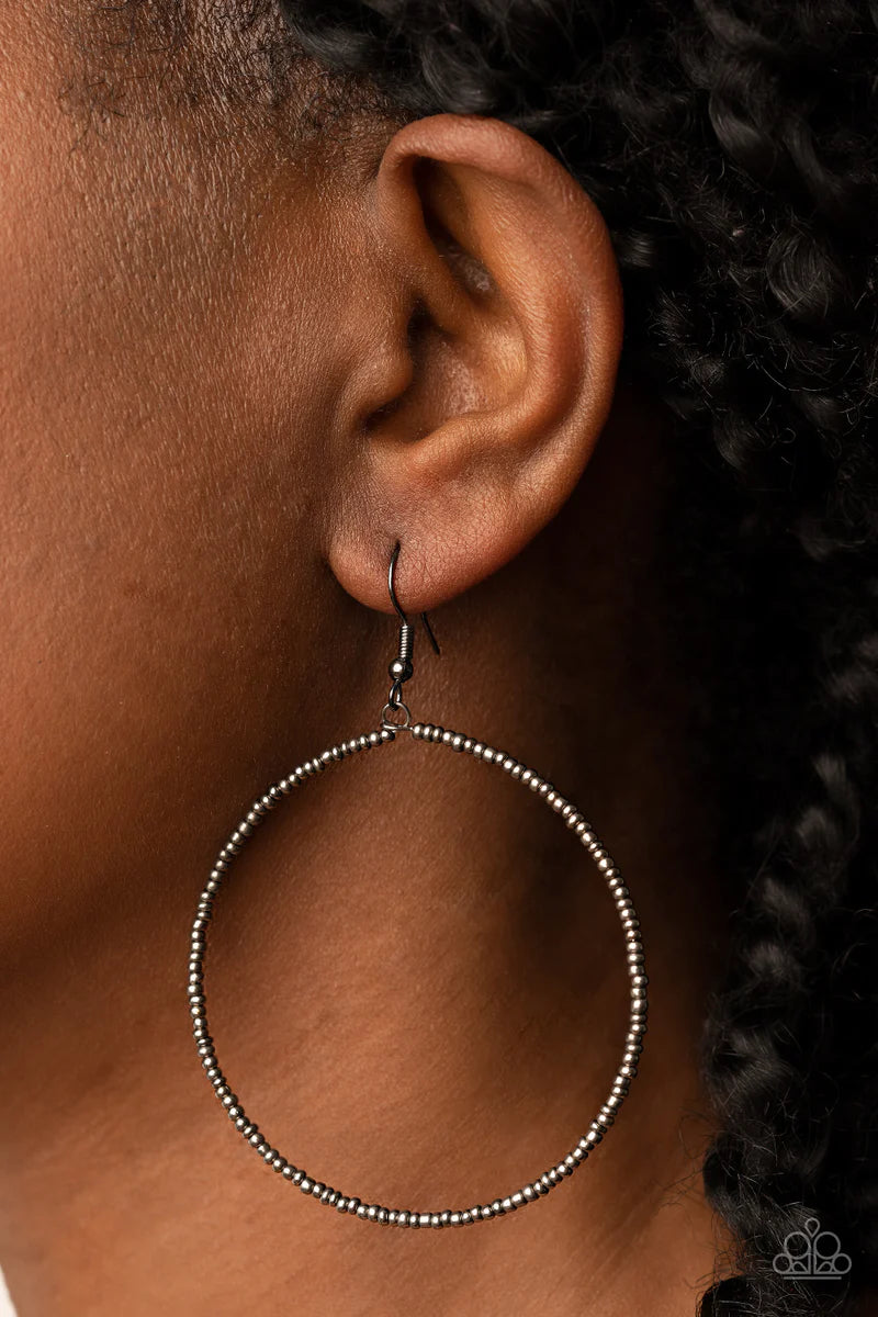 Paparazzi Accessories Basically Beaded - Black Dainty gunmetal seed beads are delicately threaded along a gunmetal wire hoop, creating a causal pop of metallic shimmer. Earring attaches to a standard fishhook fitting. Sold as one pair of earrings. Jewelry