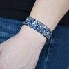 Paparazzi Accessories Totally Crushed It ~Blue Bits of crushed blue stone is encrusted along the front of a black suede band. Smoky and hematite rhinestones are sprinkled along the band, adding edgy shimmer to the sassy seasonal palette. Features an adjus