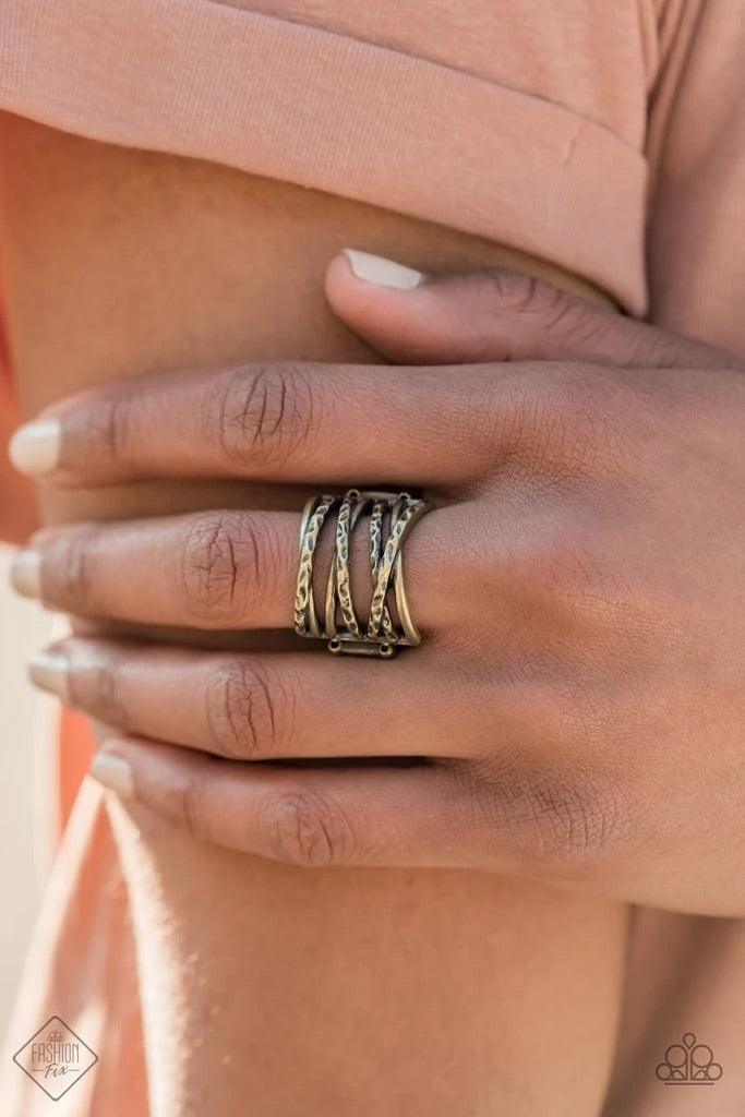 Paparazzi Accessories Switching Gears - Brass Brushed in an antiqued shimmer, hammered brass bars twisted in texture crisscross across the finger for a gritty stacked look. Features a stretchy band for a flexible fit. Sold as one individual ring. Jewelry