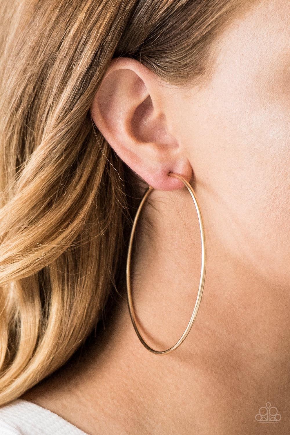 Paparazzi Accessories Meet Your Maker - Gold A skinny ribbon of gold curls into a bold hoop for a dramatic look. Earring attaches to a standard post fitting. Hoop measures 3โ in diameter. Jewelry