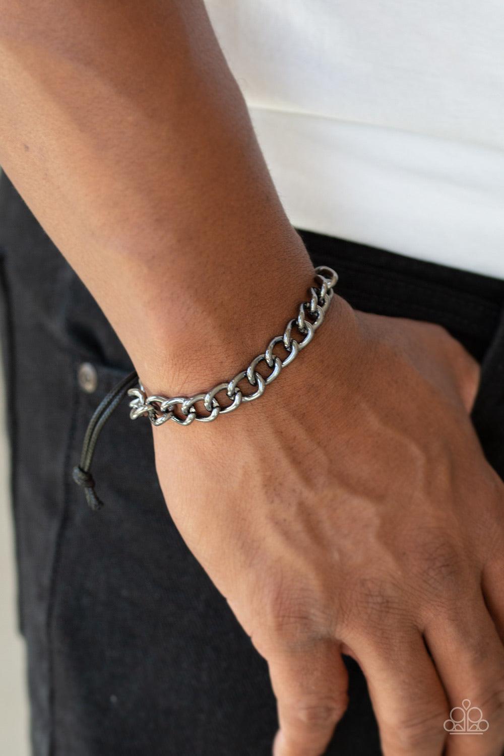 Paparazzi Accessories Sideline - Black Shiny black cording knots around the ends of a classic gunmetal cable chain that is wrapped across the top of the wrist for a versatile look. Features an adjustable sliding knot closure. Sold as one individual bracel