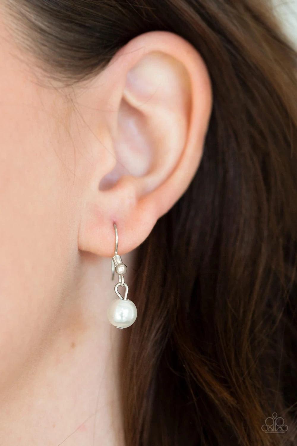 Paparazzi Accessories Timeless Tassels - Silver Dainty silver pearls and sparkling white crystal-like beads gives way to two shimmery silver chain tassels. Infused with ornate silver beads, strands of matching beads trickle down the tassels for a refined