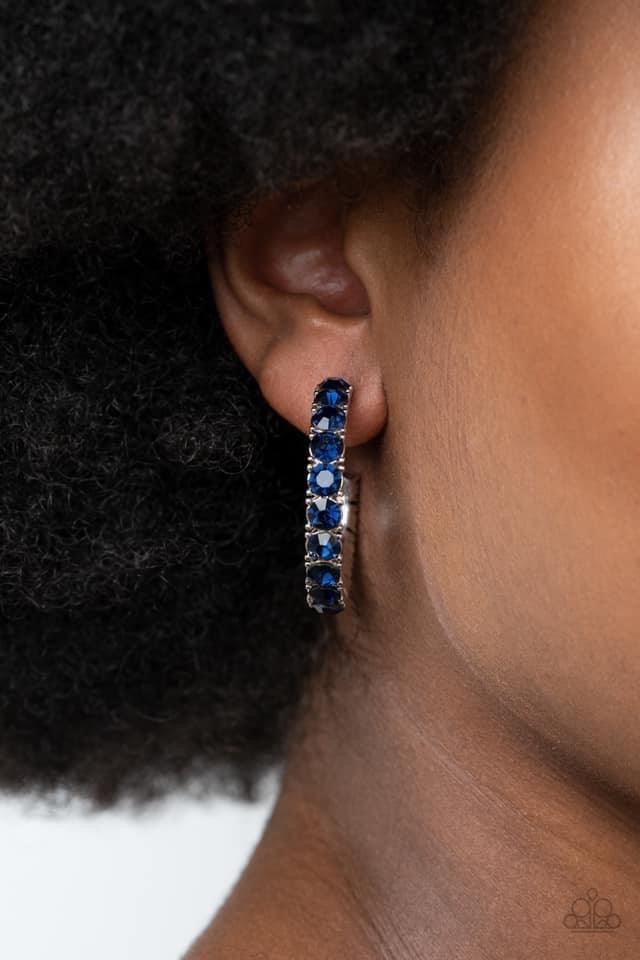 Paparazzi Accessories Classy Is In Session - Blue An oversized collection of glittery blue rhinestones are encrusted along a textured silver hoop, creating a glamorous sparkle. Earring attaches to a standard post fitting. Hoop measures approximately 1 1/2
