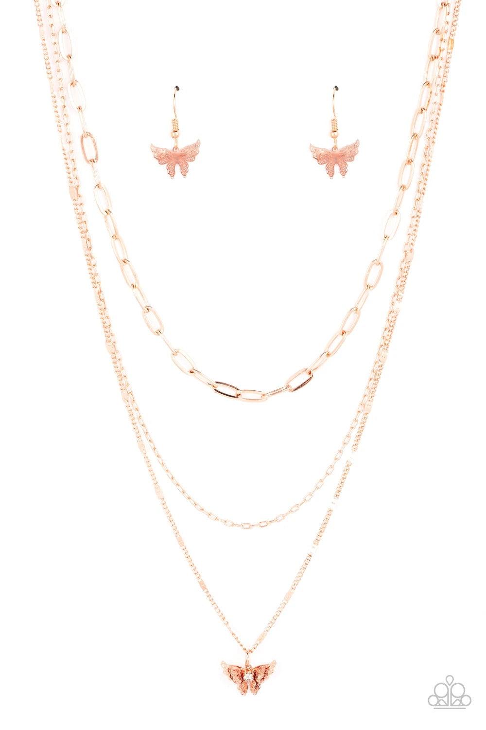 Paparazzi Accessories Bountiful Butterflies - Copper Dotted with a dainty white rhinestone, a decoratively layered shiny copper butterfly swings from the bottom of a display of mismatched shiny copper chains for a whimsically fluttering fashion. Features