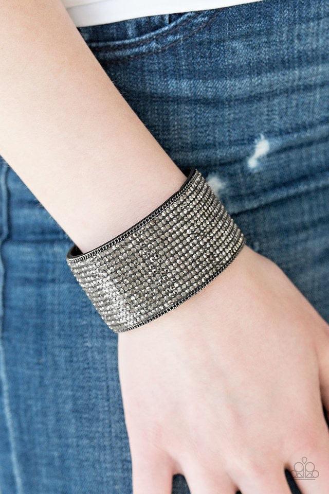 Paparazzi Accessories Glitter Gossip - Black Row after row of glittery hematite rhinestones are encrusted along a thick black suede band, creating blinding shimmer across the wrist. Features an adjustable snap closure. Sold as one individual bracelet. Jew