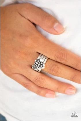 Paparazzi Accessories The ISLAND Is Your ISLAND - Silver A trio of flowers bloom from the center of a thick silver band rippling with hammered and linear textures for a seasonal look. Features a stretchy band for a flexible fit. Sold as one individual rin