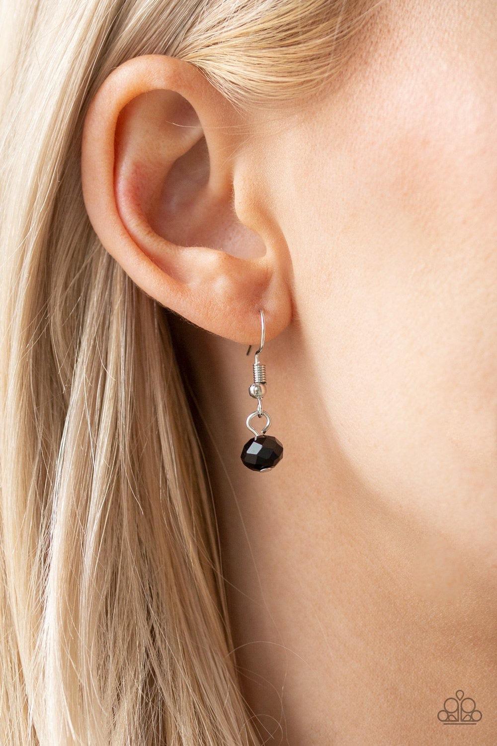 Paparazzi Accessories Party Spree - Black A collection of metallic net covered beads, shiny silver beads, and glittery black crystal-like beads swing from the bottom of interlocking silver chains, creating a refined fringe below the collar. Features an ad