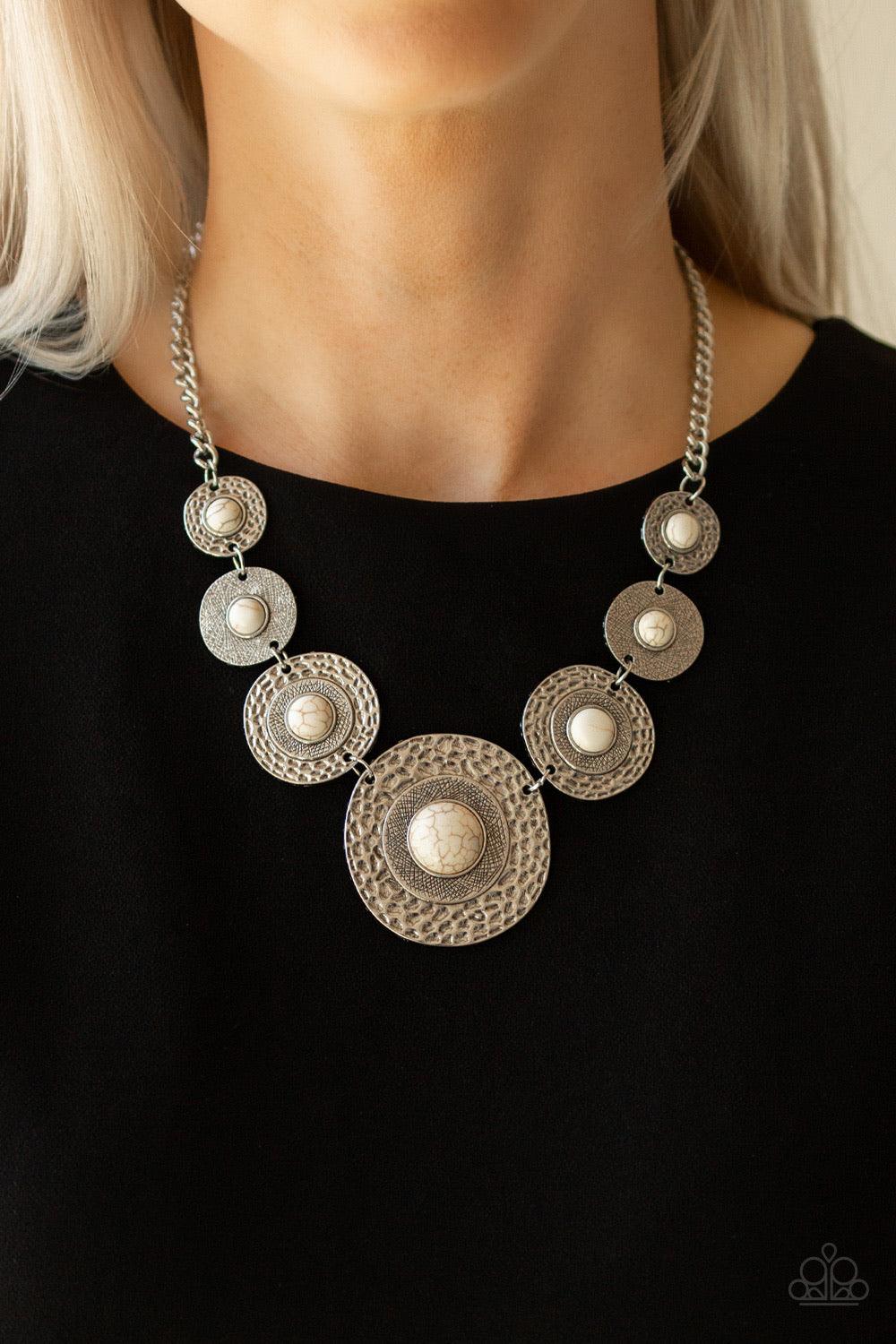 Paparazzi Accessories Tiger Trap - White Dotted with smooth white stone centers, mismatched hammered silver frames gradually increase in size as they link below the collar for a fierce look. Features an adjustable clasp closure. Jewelry