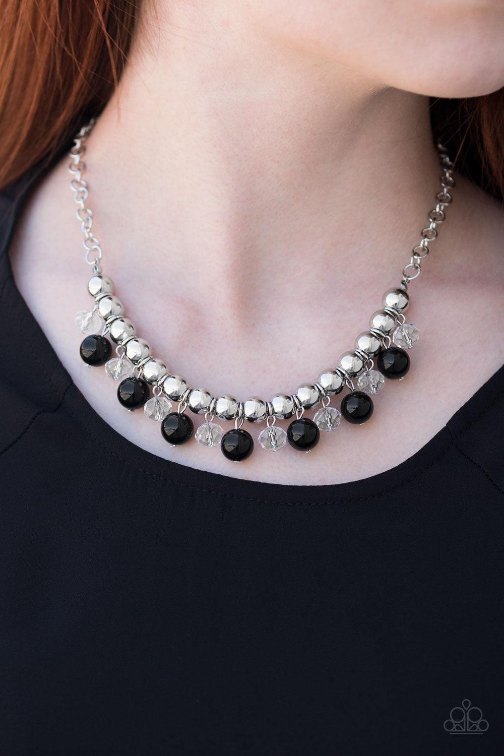 Paparazzi Accessories Power Trip - Black Infused with a bold silver chain, classic silver beads are threaded along a skinny wire below the collar. Polished black and faceted crystal-like beads swing from the bottom of the silver beads, creating a refined
