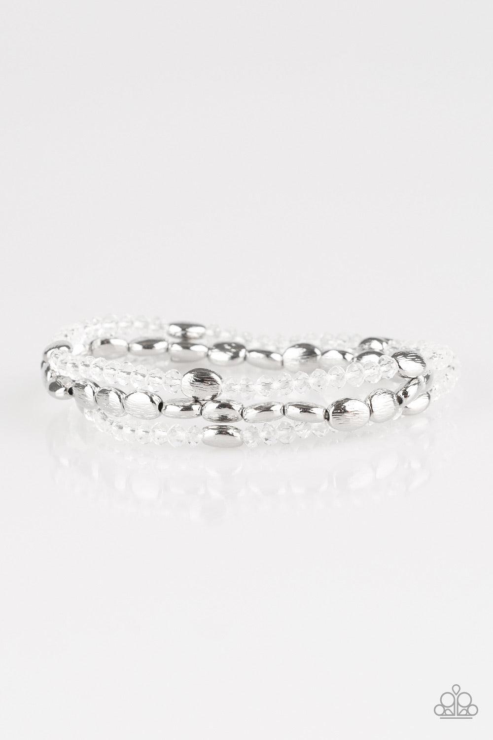 Paparazzi Accessories Hello Beautiful - White Infused with hints of silver, dainty white crystal-like beads are threaded along stretchy bands, creating whimsical layers across the wrist. Sold as one set of three bracelets. Jewelry