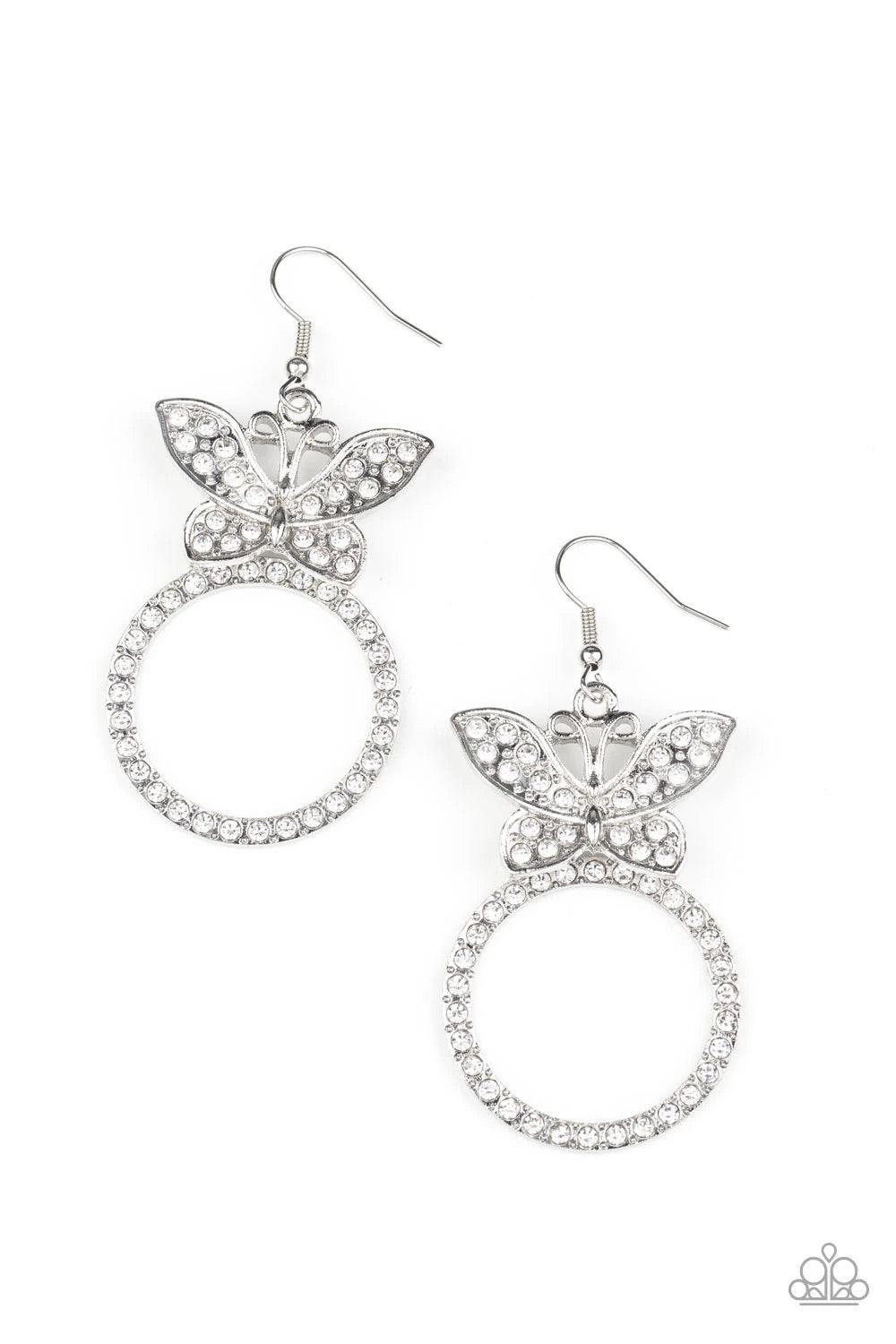 Paparazzi Accessories Paradise Found - White A white rhinestone encrusted silver butterfly flutters atop a silver ring dotted in matching white rhinestones, resulting in a dazzling statement piece. Earring attaches to a standard fishhook fitting. Sold as