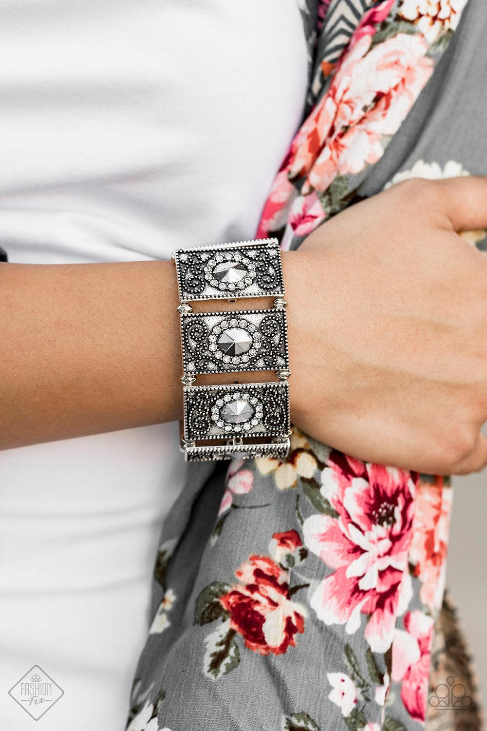 Paparazzi Accessories Tycoon Texture - Silver Featuring faceted silver beaded and white rhinestone encrusted centers, rectangular filigree filled silver frames are threaded along a stretchy band around the wrist for a vintage inspired look. Jewelry
