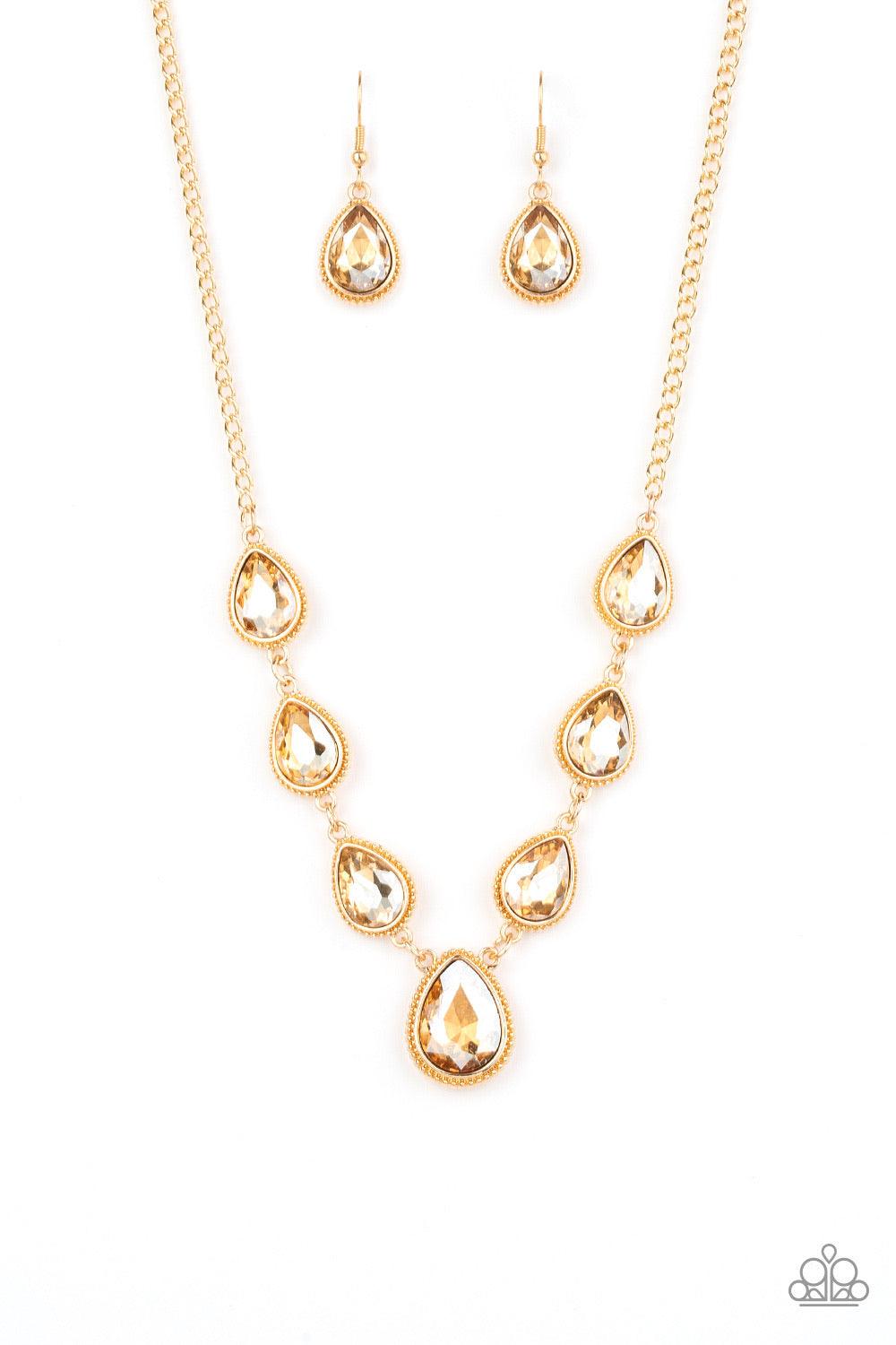 Paparazzi Accessories Socialite Social - Gold Featuring ornate gold frames, golden teardrop gems link below the collar in a timeless fashion. The largest teardrop swings from the center, creating a glamorous pendant. Features an adjustable clasp closure.