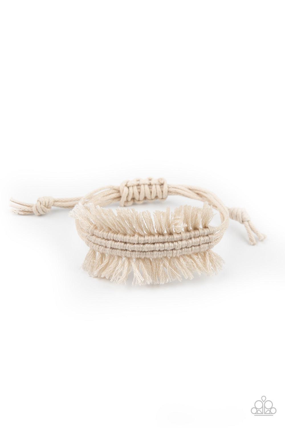 Paparazzi Accessories Make Yourself at HOMESPUN - White Strands of shiny white twine-like cording decoratively knot around the wrist, creating a rustic fringed centerpiece. Features an adjustable sliding knot closure. Sold as one individual bracelet. Jewe
