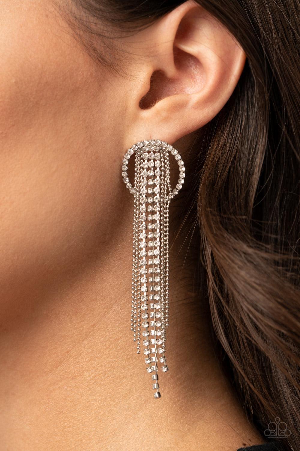 Paparazzi Accessories Dazzle By Default - White Dainty strands of glassy white rhinestones and shimmery silver ball-chain stream from the top of a bedazzled white rhinestone hoop, creating a dazzling fringe. Earring attaches to a standard post fitting. So