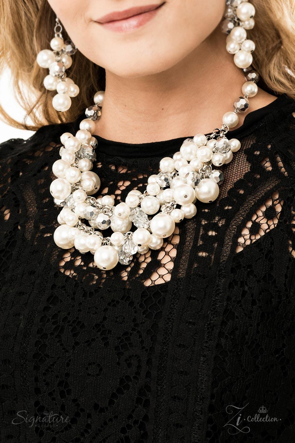 Paparazzi Accessories The Lauren A timeless collection of bubbly white pearls and faceted crystal-like beads dances along the collar in two rows of dramatic clusters. One side of the glassy crystals have been dipped in a flashy metallic finish, adding som