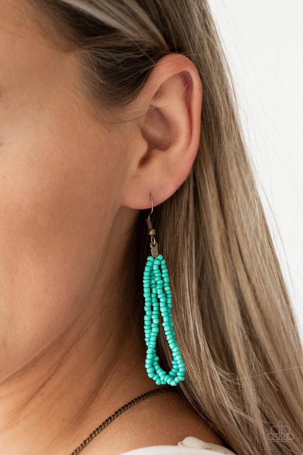 Paparazzi Accessories Badlands Beauty - Blue Infused with blue, brass, and red seed beads, a colorful dream catcher like pendant swings from the bottom of a lengthened brass chain for a tribal inspired look. Features an adjustable clasp closure. Jewelry