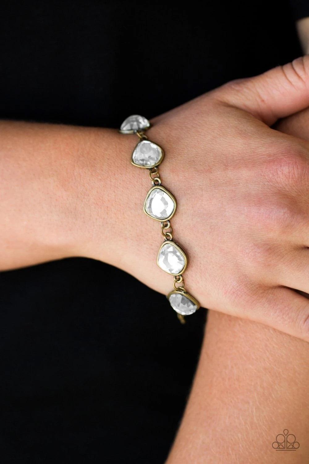 Paparazzi Accessories Perfect Imperfection - Brass Featuring antiqued brass frames, imperfect glassy white gems link around the wrist for a glamorous vintage inspired look. Features an adjustable clasp closure. Sold as one individual bracelet. Jewelry
