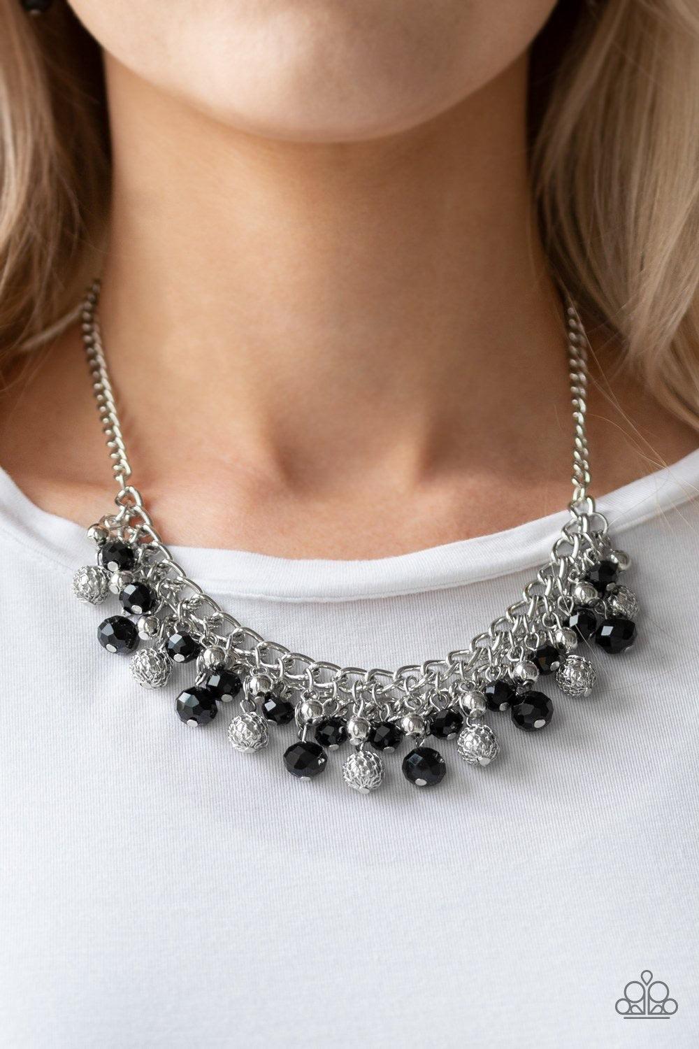 Paparazzi Accessories Party Spree - Black A collection of metallic net covered beads, shiny silver beads, and glittery black crystal-like beads swing from the bottom of interlocking silver chains, creating a refined fringe below the collar. Features an ad