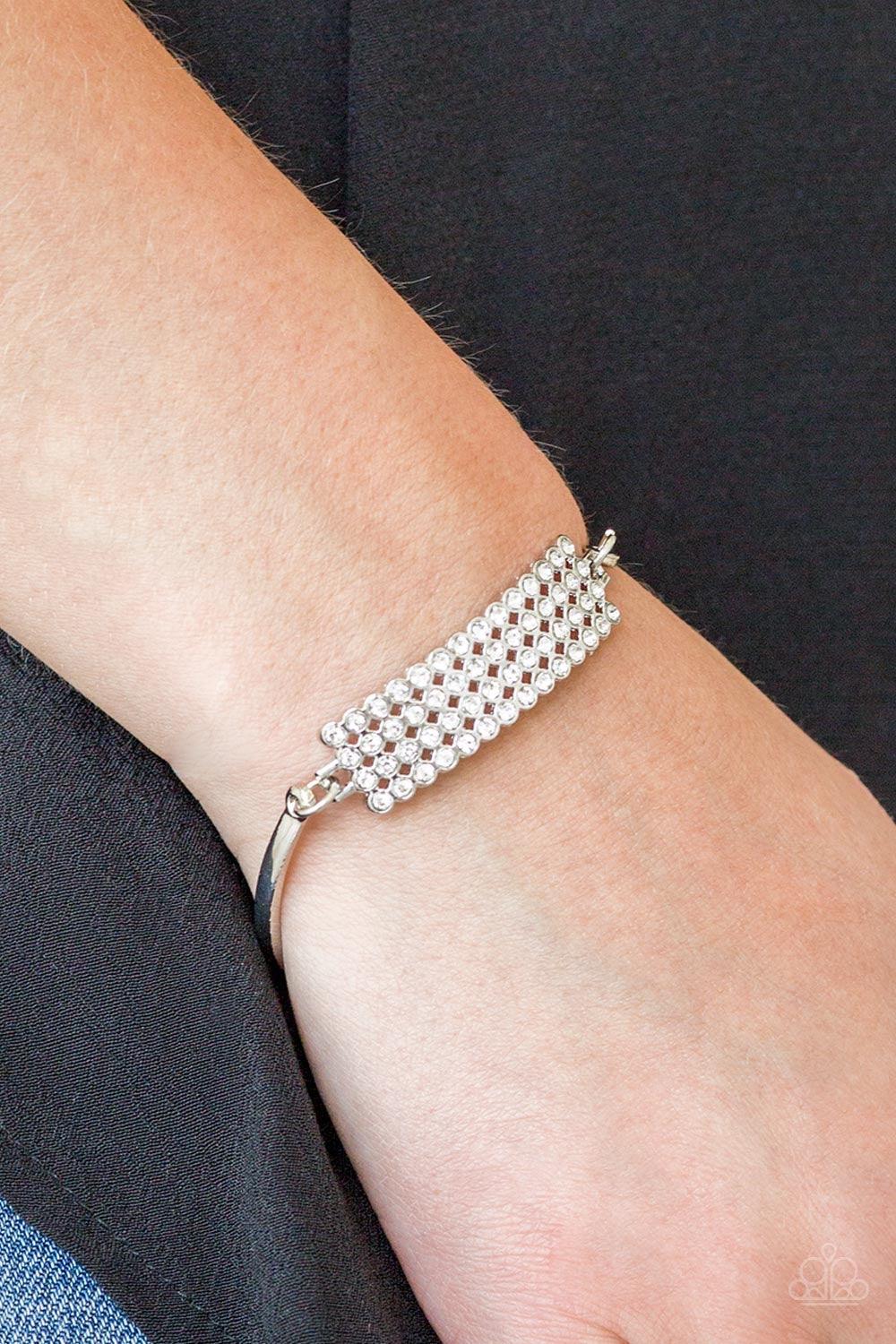 Paparazzi Accessories Top-Top Class - White Row after row of glassy white rhinestones stack into a gorgeous rectangular pendant. Attached to two arcing silver bars, the glittery pendant sits atop the wrist for an undeniably glamorous look. Features an adj