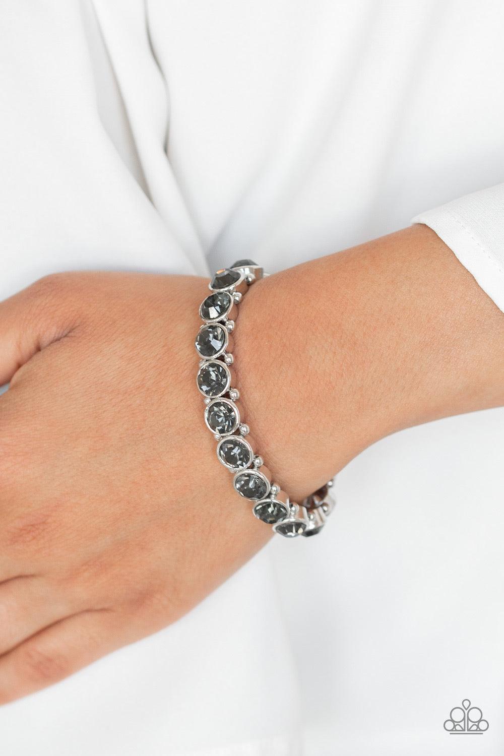 Paparazzi Accessories Sugar-Coated Sparkle - Silver Infused with dainty silver beads, smoky rhinestone encrusted frames are threaded along stretchy bands around the wrist for a glamorous look. Jewelry
