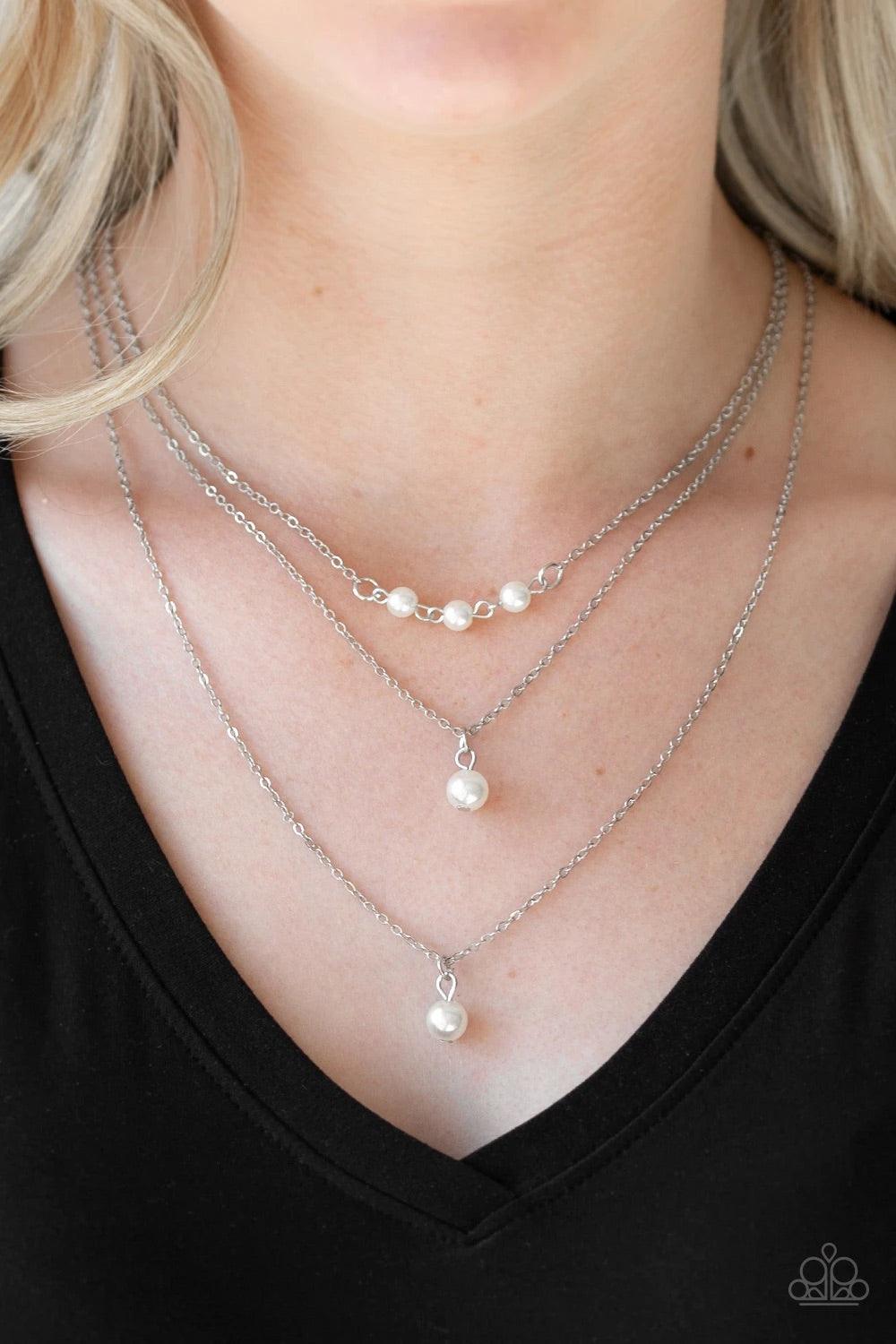 Paparazzi Accessories High Heels and Hustle - White A trio of pearly white beads give way to layers of solitaire white pearl pendants below the collar for a refined flair. Features an adjustable clasp closure. Sold as one individual necklace. Includes one