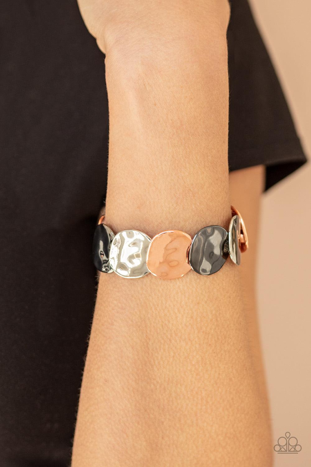 Paparazzi Accessories Disc Disco - Multi A hammered collection of asymmetrical hammered silver, shiny copper, and gunmetal discs are threaded along stretchy bands, overlapping around the wrist for a refined flair. Sold as one individual bracelet. Jewelry