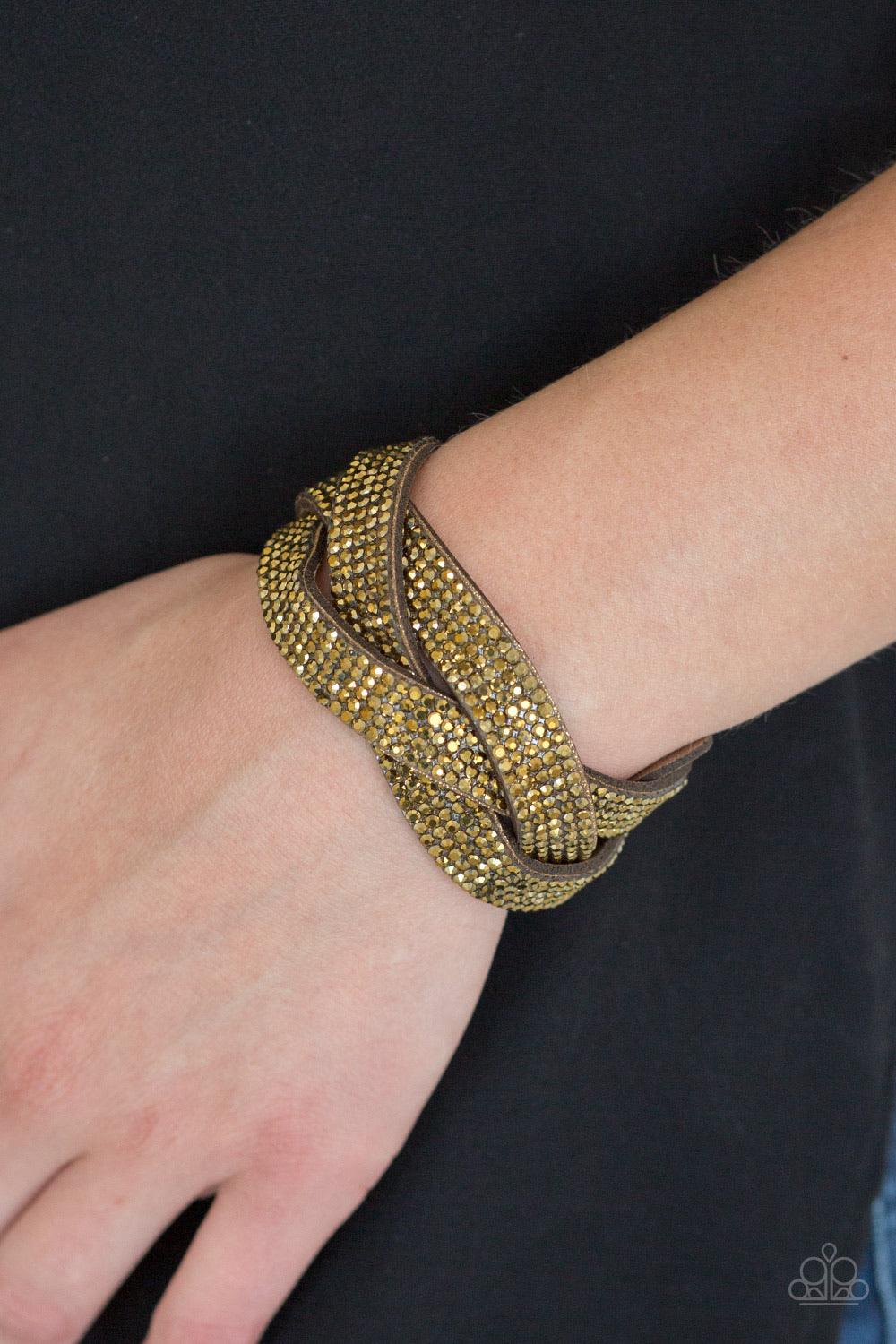 Paparazzi Accessories Nice Girls Finish Last - Brass Encrusted in row after row of glittery aurum rhinestones, three sparkling brown suede bands braid across the wrist for a sassy look. Features an adjustable snap closure. Sold as one individual bracelet.