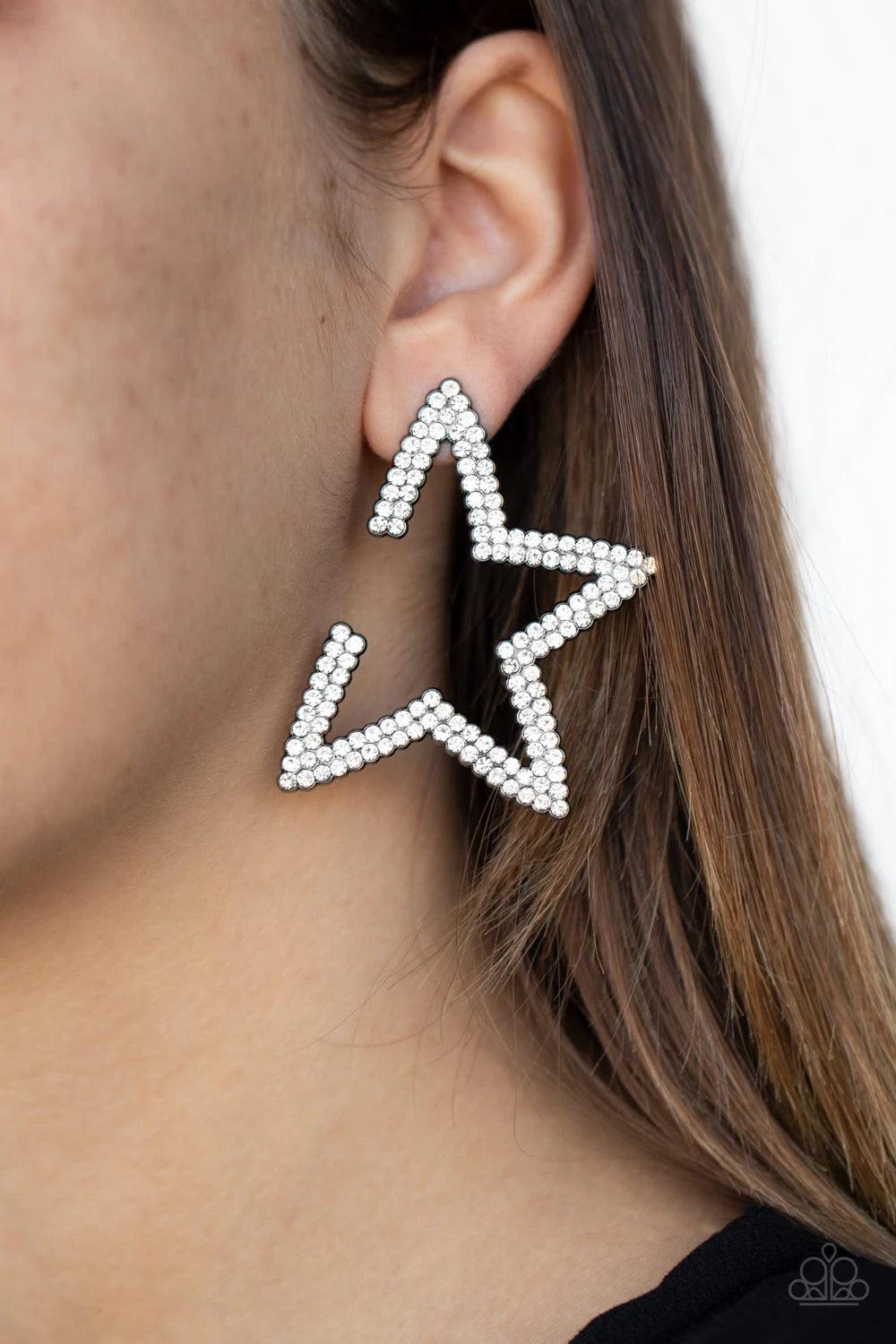 Paparazzi Accessories Star Player - Black Encrusted in two rows of glassy white rhinestones, a gunmetal star frame dots the ear for a stellar shimmer. To flatter the natural contour of the face, one side angle of the star frame is intentionally left open.