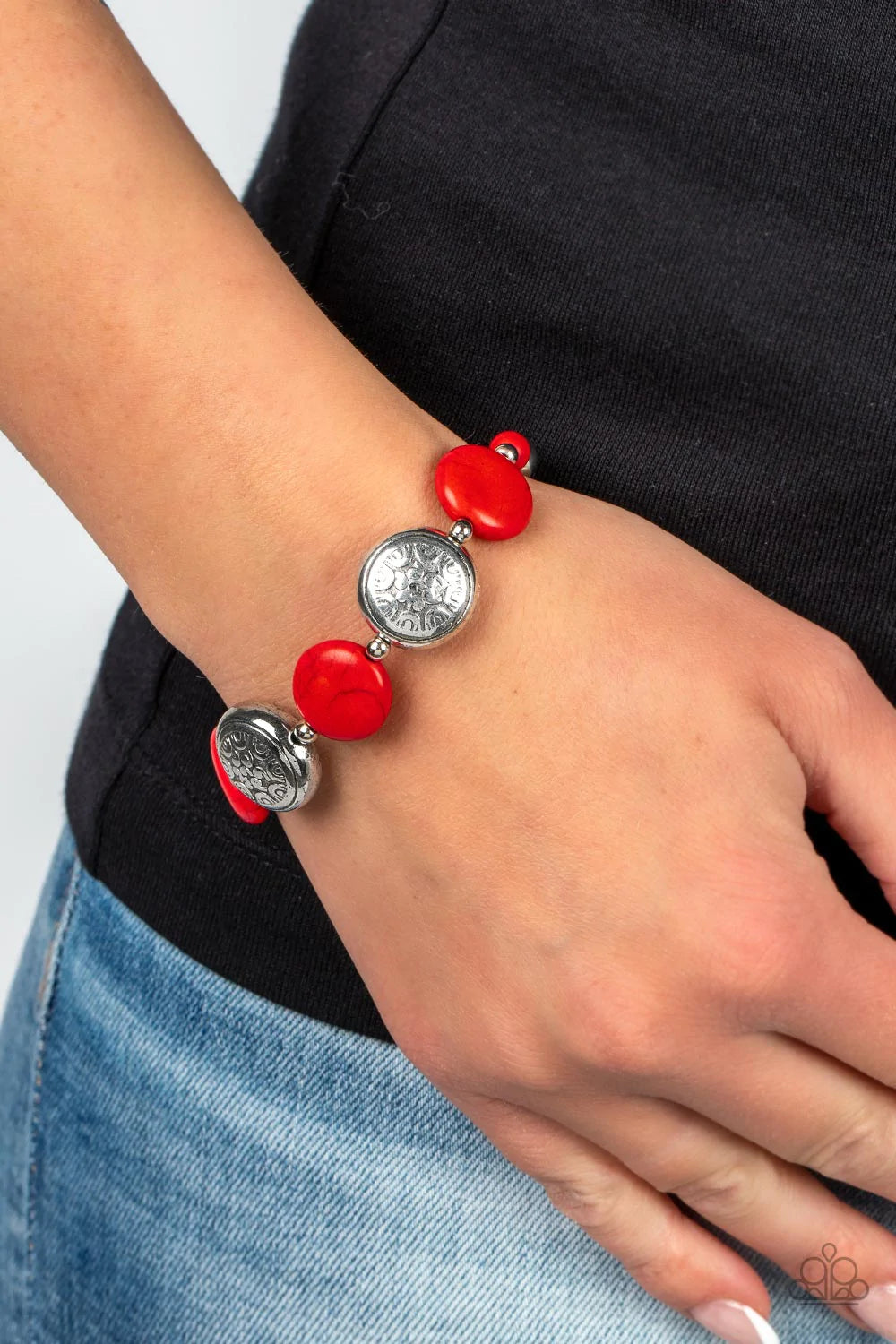 Paparazzi Accessories Oasis Orchard - Red Infused with silver beads and red stone accents, flat red stone beads alternate with floral silver frames along an invisible wire around the wrist for an earthy pop of color. Features an adjustable clasp closure.