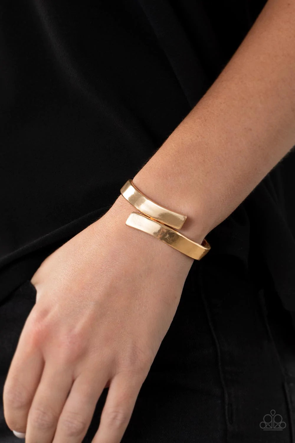 Paparazzi Accessories Dare To Flare - Gold Two oversized gold ribbons delicately overlap across the center of the wrist, creating a stylish and stackable bangle-like cuff. Features a hinged closure. Sold as one individual bracelet.