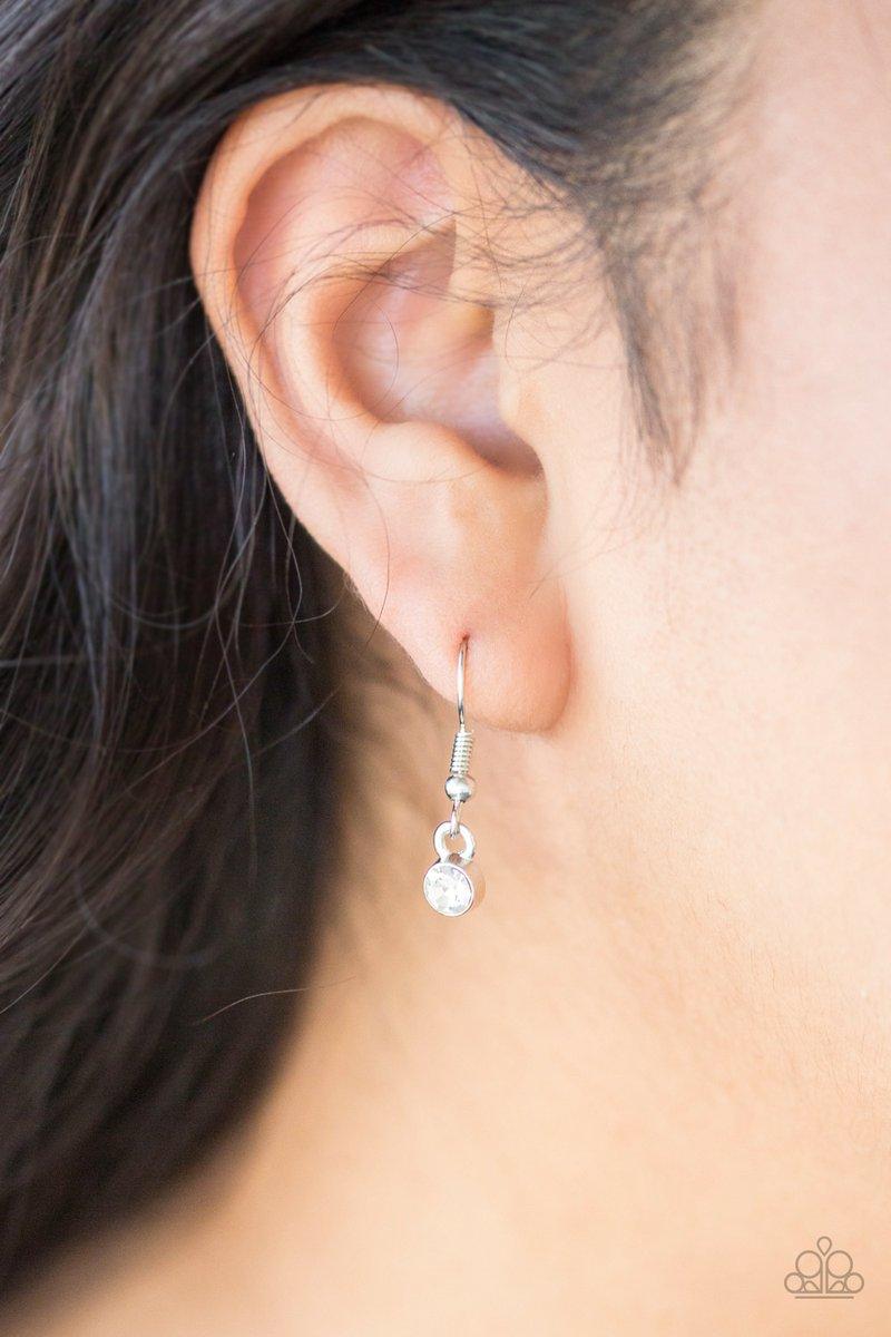 Paparazzi Accessories Money Mood - White Ringed in a studded silver frame, glittery white rhinestones collect into glamorous pendant at the bottom of a lengthened silver chain for a refined flair. Features an adjustable clasp closure. Sold as one individu