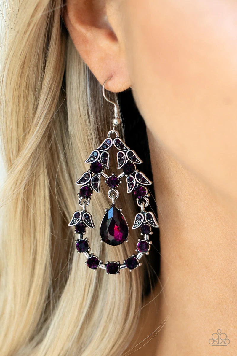 Paparazzi Accessories Garden Decorum - Purple A solitaire purple teardrop rhinestone swings from the top of an ornately hinged teardrop frame adorned in purple rhinestone dotted leafy silver frames, creating a glamorous centerpiece. Earring attaches to a
