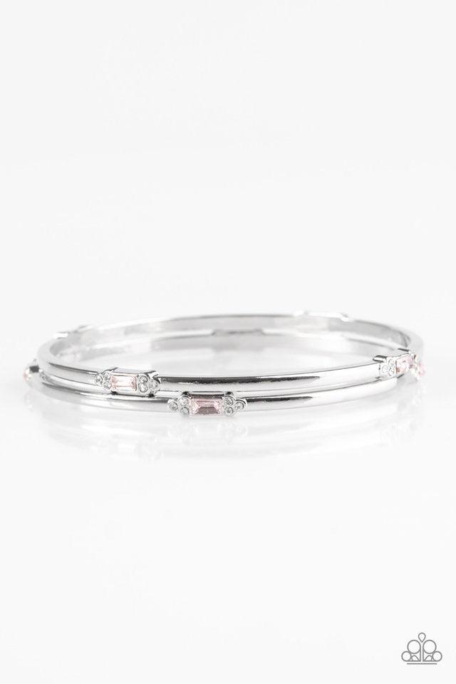 Paparazzi Accessories BRIGHT Here, BRIGHT Now - Pink Featuring elegant round and emerald style cuts, glittery pink and white rhinestones are pressed into two shimmery silver bangles for a refined look. Jewelry
