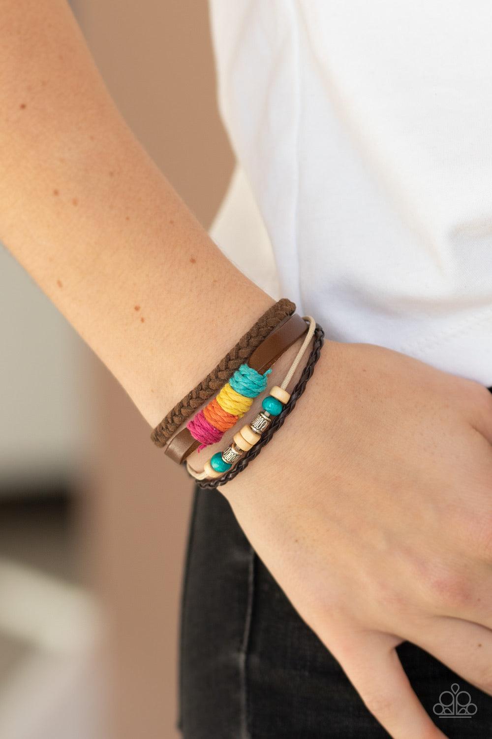 Paparazzi Accessories Rogue Rainbow - Multi Infused with wooden, silver, and rainbow threaded accents, mismatched leather and twine bands layer around the wrist for a colorful look. Features an adjustable sliding knot closure. Jewelry