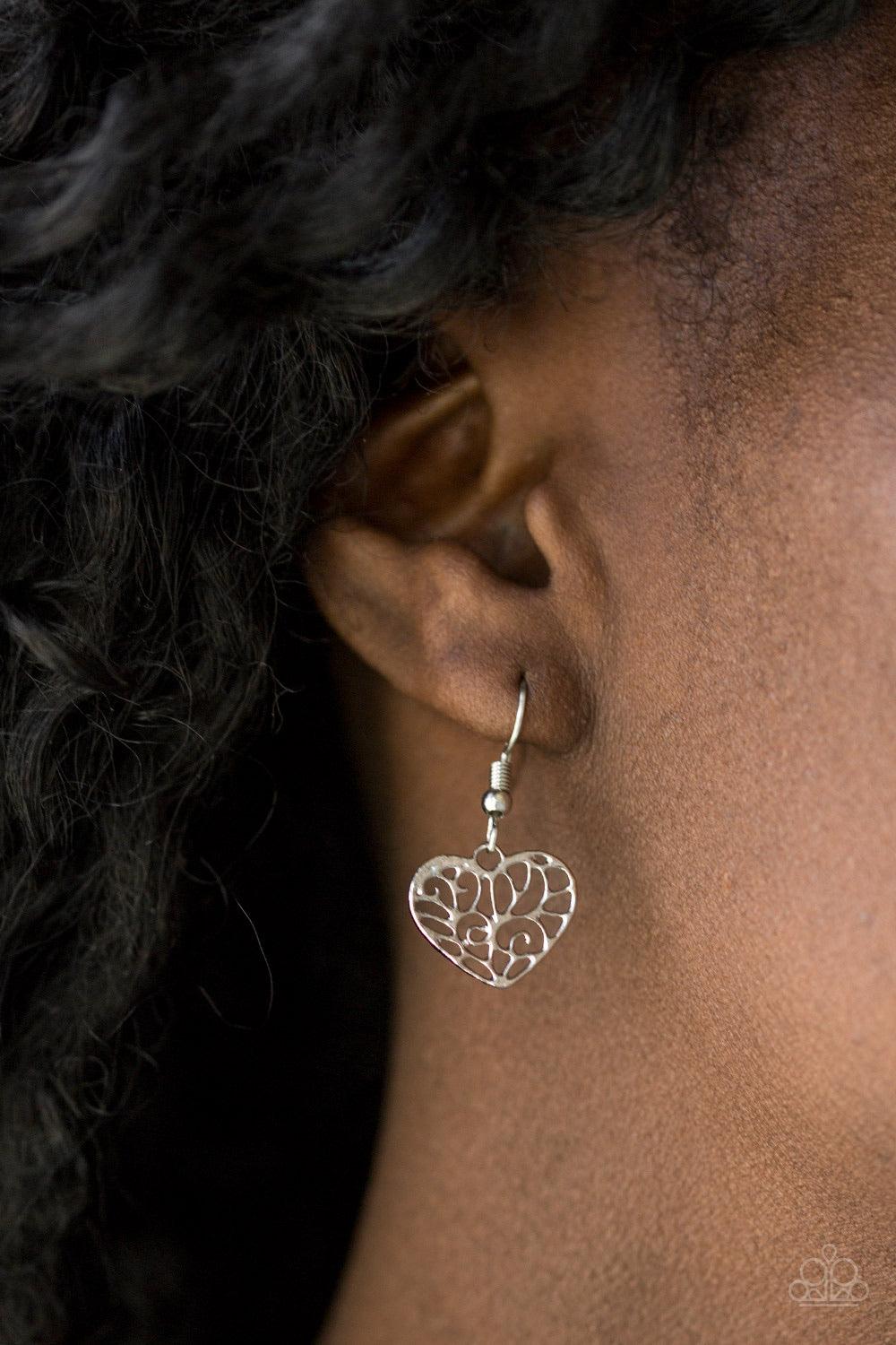 Paparazzi Accessories Less is AMOUR - Silver Infused with vine-like filigree filled centers, dainty silver hearts swing from the bottom of a shimmery silver chain below the collar for a whimsical look. Features an adjustable clasp closure. Sold as one ind