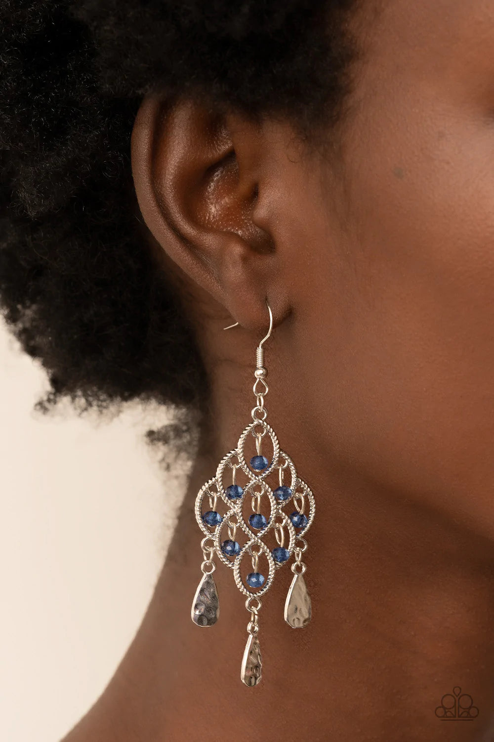 Paparazzi Accessories Sentimental Shimmer - Blue Hammered silver teardrops swing from the bottom of a frame composed of silvery ropelike filigree that gently loops into an airy diamond shape. Tiers of dainty blue crystal-like beads cascade from the frilly