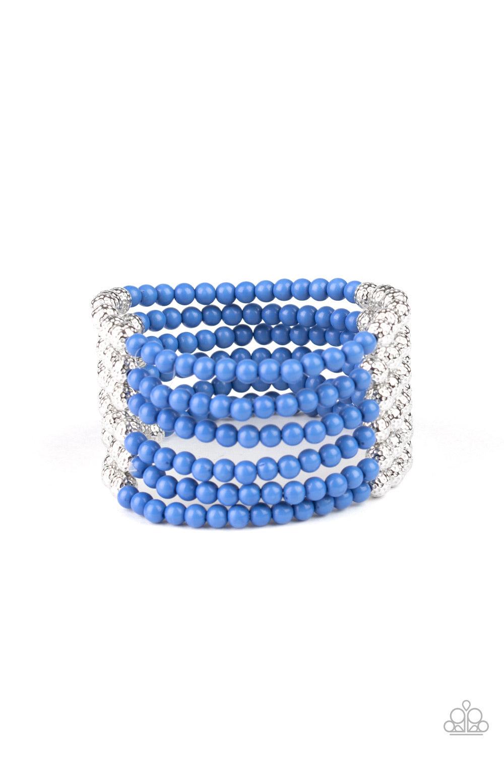 Paparazzi Accessories LAYER It On Thick - Blue Held together with silver fittings, row after row of ornate silver and polished blue beads are threaded along stretchy bands around the wrist of a colorful fashion. Jewelry