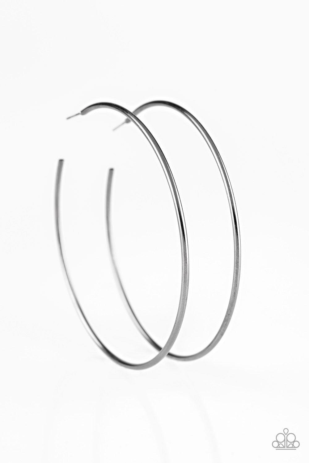 Paparazzi Accessories Meet Your Maker - Black A skinny ribbon of gunmetal curls into a bold hoop for a dramatic look. Earring attaches to a standard post fitting. Hoop measures 3โ in diameter. Jewelry