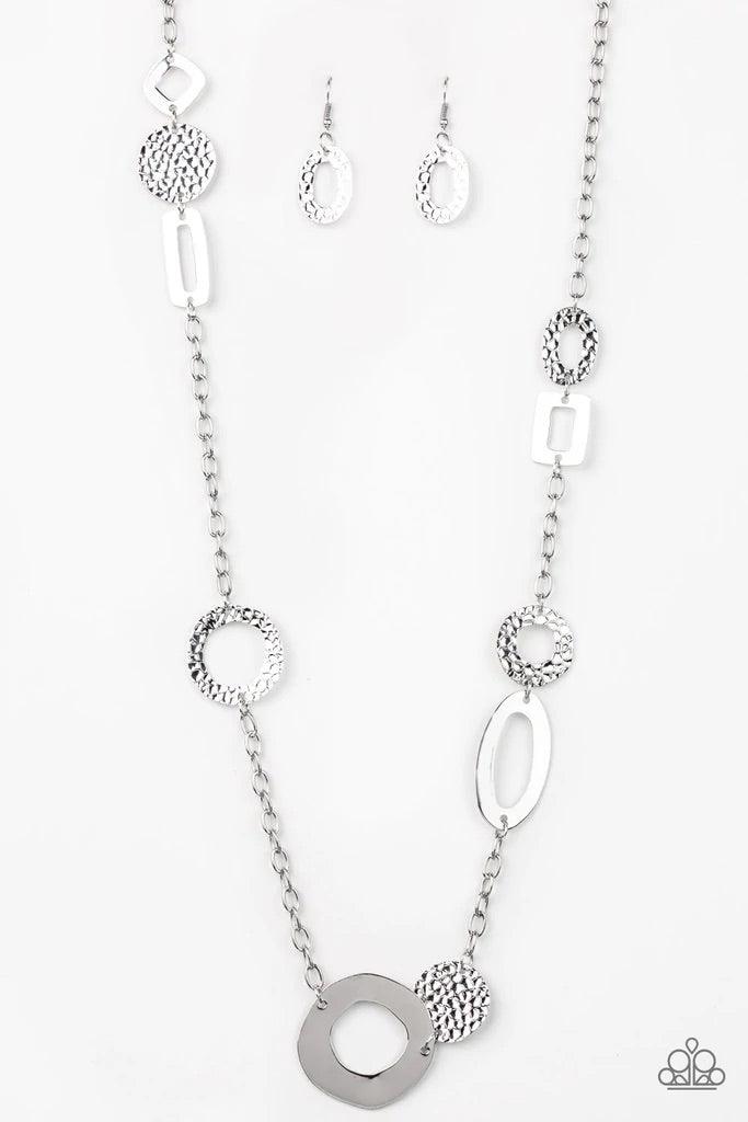 Paparazzi Accessories Metro Scene - Silver A collection of mismatched smooth and textured silver frames connect into an abstract chain across the chest. Features an adjustable clasp closure. Sold as one individual necklace. Includes one pair of matching e