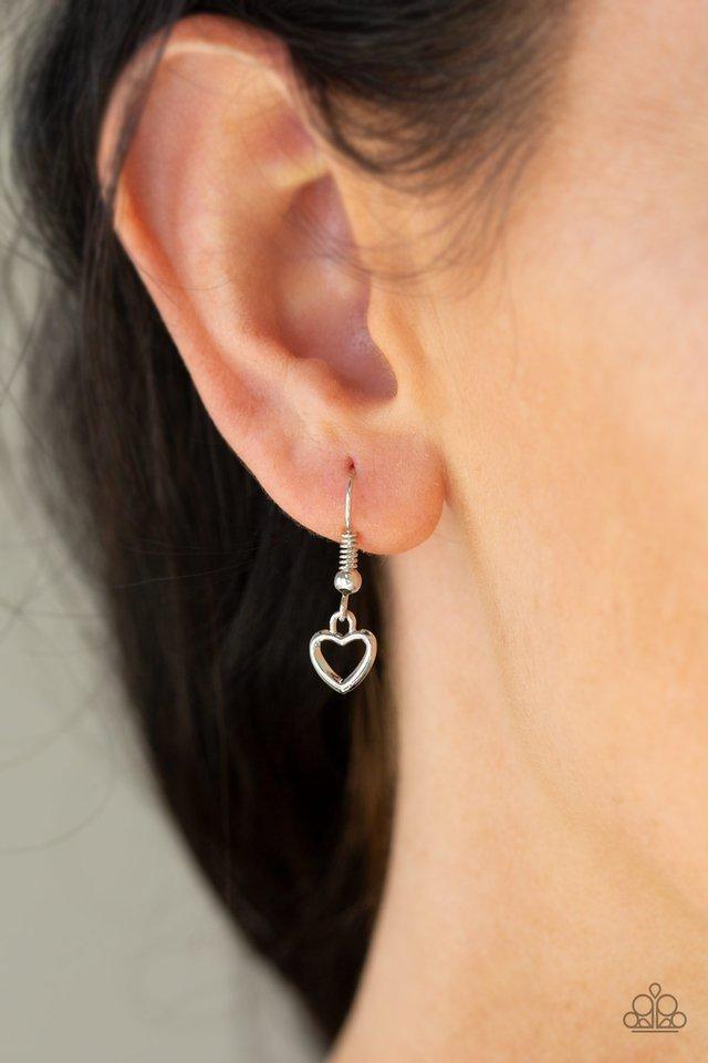 Paparazzi Accessories Hearty Heirloom - Silver Three shimmery silver chains cascade down the chest. Two dainty silver heart charms swing from the uppermost chains, giving way to a dramatically oversized silver pearl for a romantic finish. Features an adju