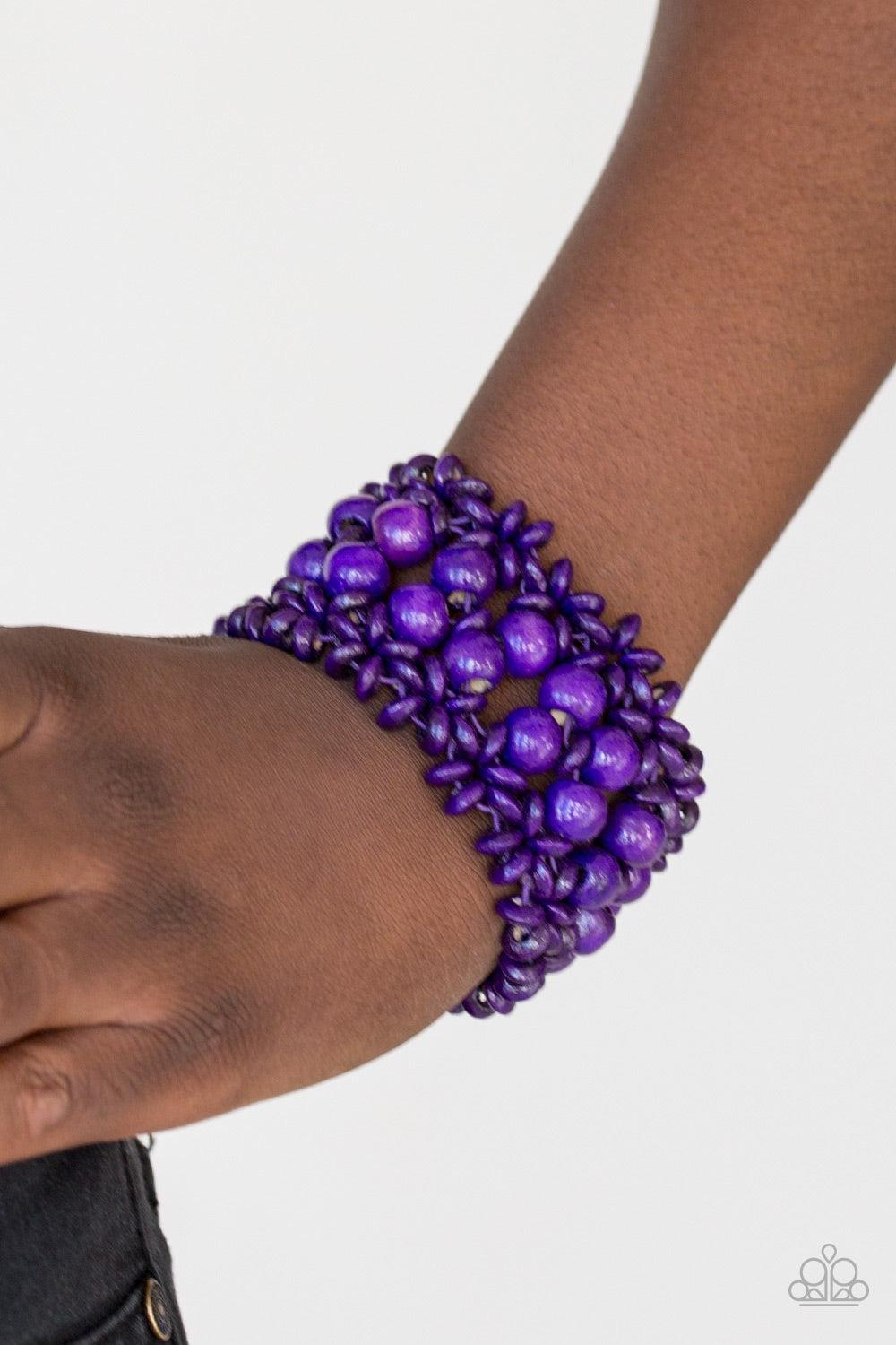 Paparazzi Accessories Tropical Bliss - Purple Purple wooden accents are threaded along elastic stretchy bands, creating an ornate bracelet. Rounded purple wooden beads line the center of the summery pattern for a bold finish. Jewelry