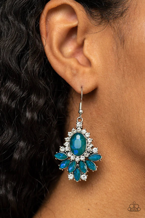 Paparazzi Accessories Magic Spell Sparkle - Green Featuring a blue opalescent finish, staggered layers of marquise cut green rhinestones fan out from an oversized green gem that is bordered in a ring of glittery white rhinestones for an enchanting finish.