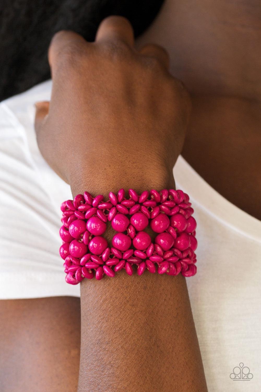 Paparazzi Accessories Tropical Bliss - Pink Pink wooden accents are threaded along elastic stretchy bands, creating an ornate bracelet. Rounded pink wooden beads line the center of the summery pattern for a bold finish. Jewelry